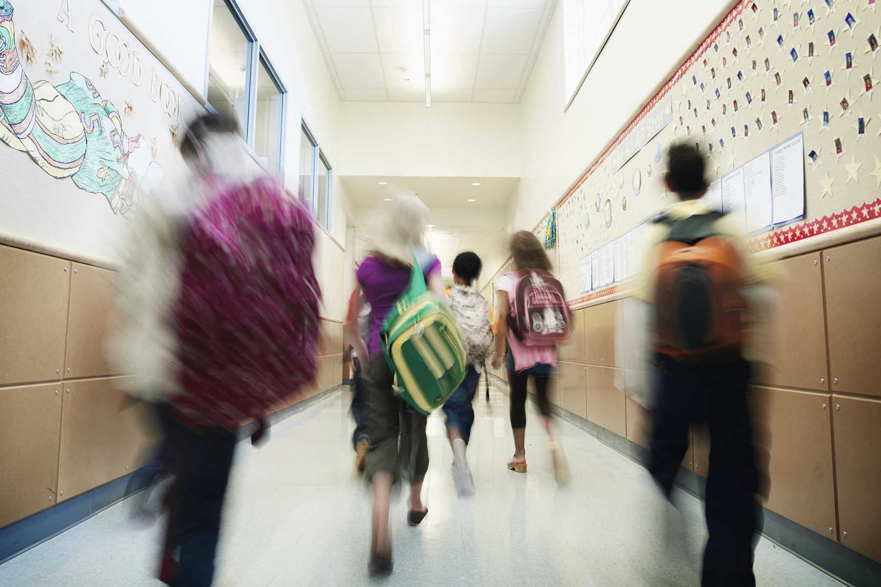 Children walk down a school hallway