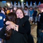 Adelita Grijalva hugs a supporter surrounded by others.