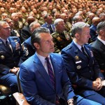 Defense Secretary Pete Hegseth sits with Chairman of the Joint Chiefs of Staff Air Force Gen. Dan Caine, third from right, and U.S. military senior leadership as they listen to President Donald Trump speaks at Marine Corps Base Quantico.