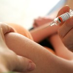 A person administers the vaccine against Hepatitis B.