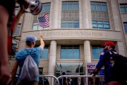 Protesters rally outside The Heritage Foundation building.
