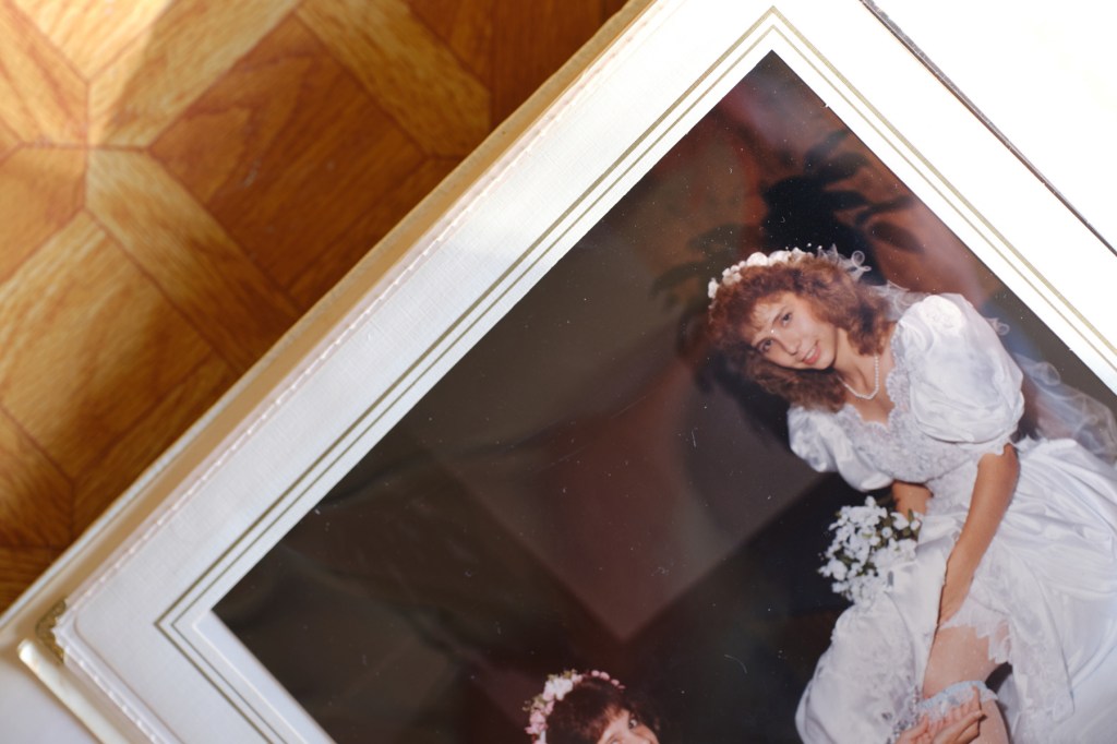 A photo of a wedding album photo of Angela in a wedding dress.