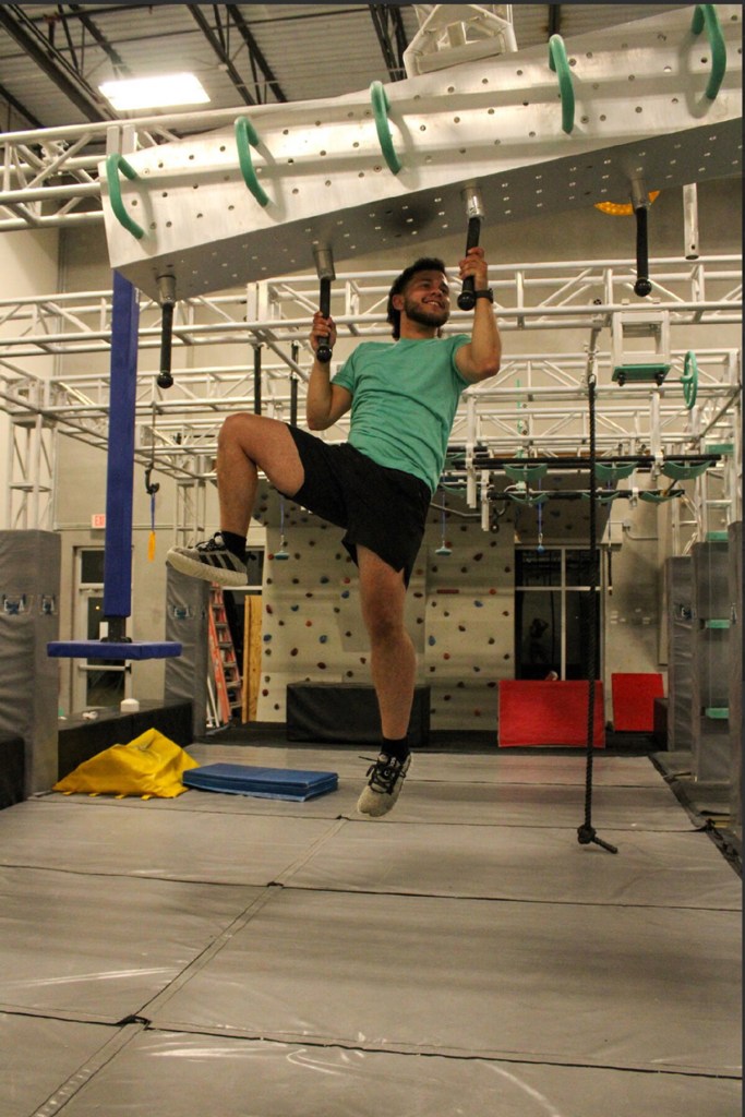 Reeves training with pull ups on an obstacle course.