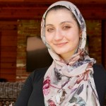 Smiling portrait of Ward Sakeik wearing a veil and looking at the camera.