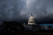 A view of the US Capitol enshrouded in dark clouds.