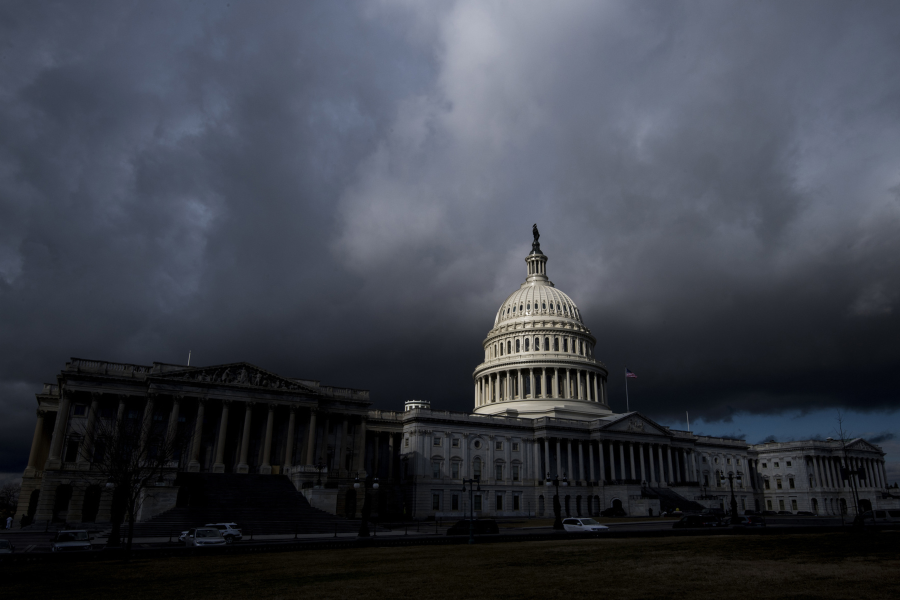 A view of the US Capitol enshrouded in dark clouds.