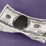 A stack of $100 bills with the silhouette of a woman replacing Benjamin Franklin’s portrait, against a purple background.