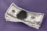 A stack of $100 bills with the silhouette of a woman replacing Benjamin Franklin’s portrait, against a purple background.
