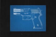 Blueprint of a firearm on black background.