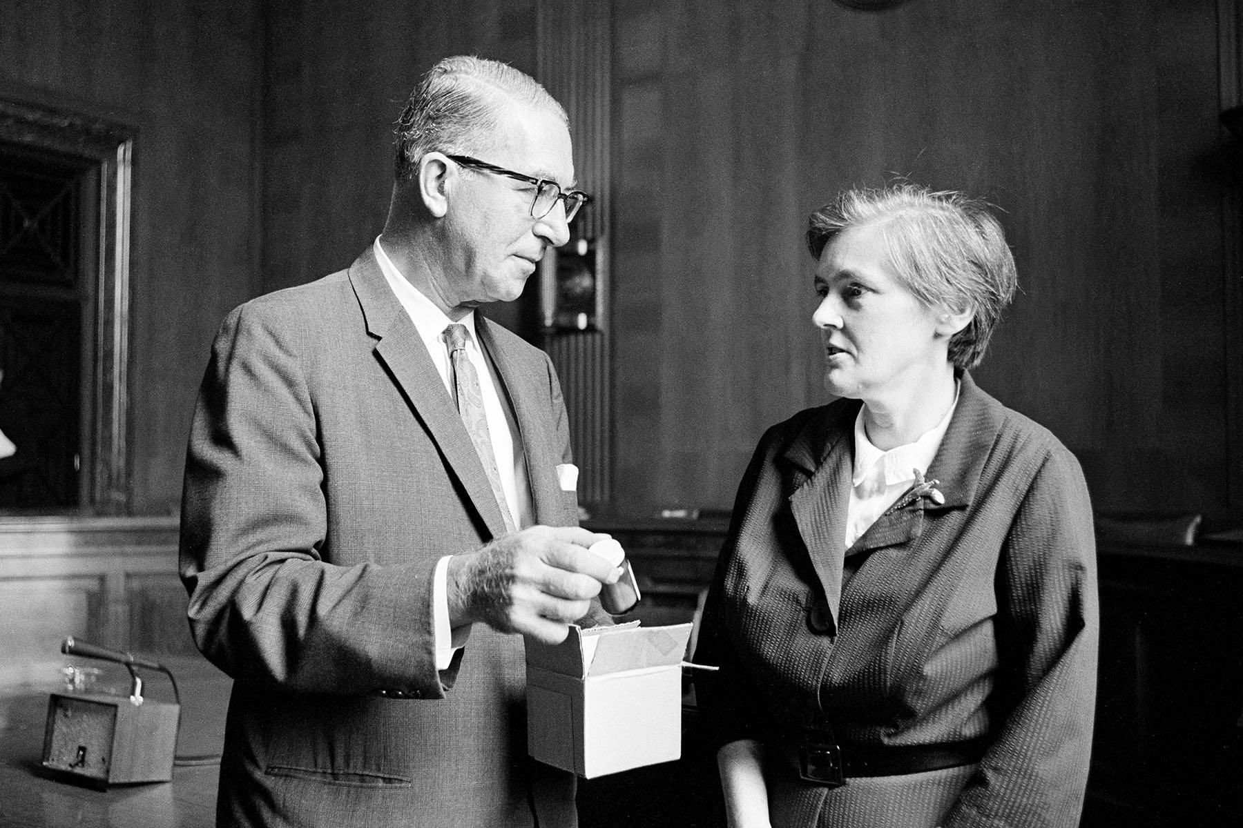 Dr. Frances Oldham Kelsey of the FDA meets with Sen. Estes Kefauver, who holds a bottle of thalidomide.