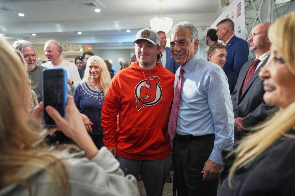 Republican candidate for governor Jack Ciattarelli poses with supporters.