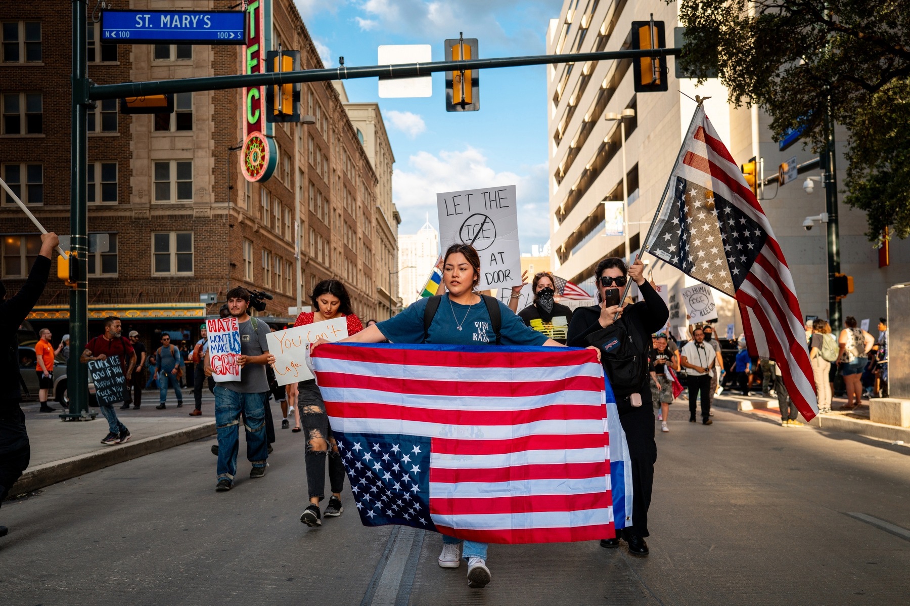 Young people march with upside down American flags at a protest in San Antonio, Texas.