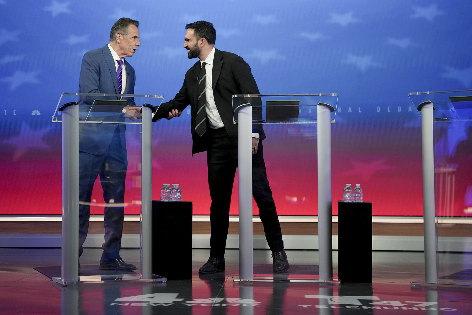 Former New York Gov. Andrew Cuomo greets Democratic nominee Zohran Mamdani before participating in a mayoral debate.