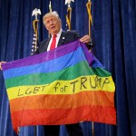 Donald Trump holds a Pride flag during a campaign rally in Greeley, Colorado.