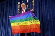 Donald Trump holds a Pride flag during a campaign rally in Greeley, Colorado.