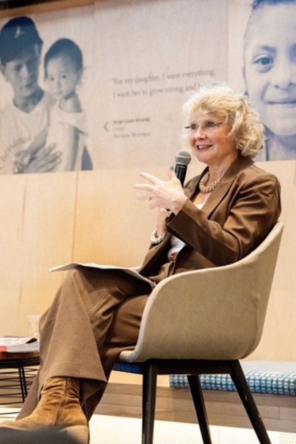 Dr. Linda Eckert speaks into a microphone.