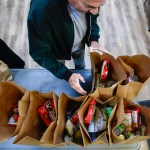 Volunteers at the Lutheran Settlement House pack bags of groceries to distribute to the local community for their daily food pantry in Philadelphia.