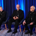 From left, Archbishop Timothy Broglio, Bishop Kevin C. Rhoades and Bishop Mark J. Seitz speak during a press conference at the United States Conference of Catholic Bishops plenary assembly.