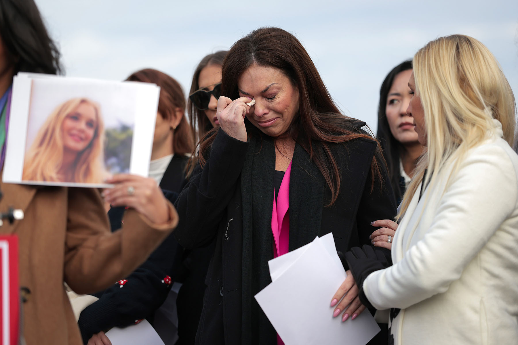 Epstein abuse survivor Haley Robson gets emotional alongside Rep. Marjorie Taylor Greene as the family of Virginia Giuffre speaks during a news conference with lawmakers outside the Capitol.