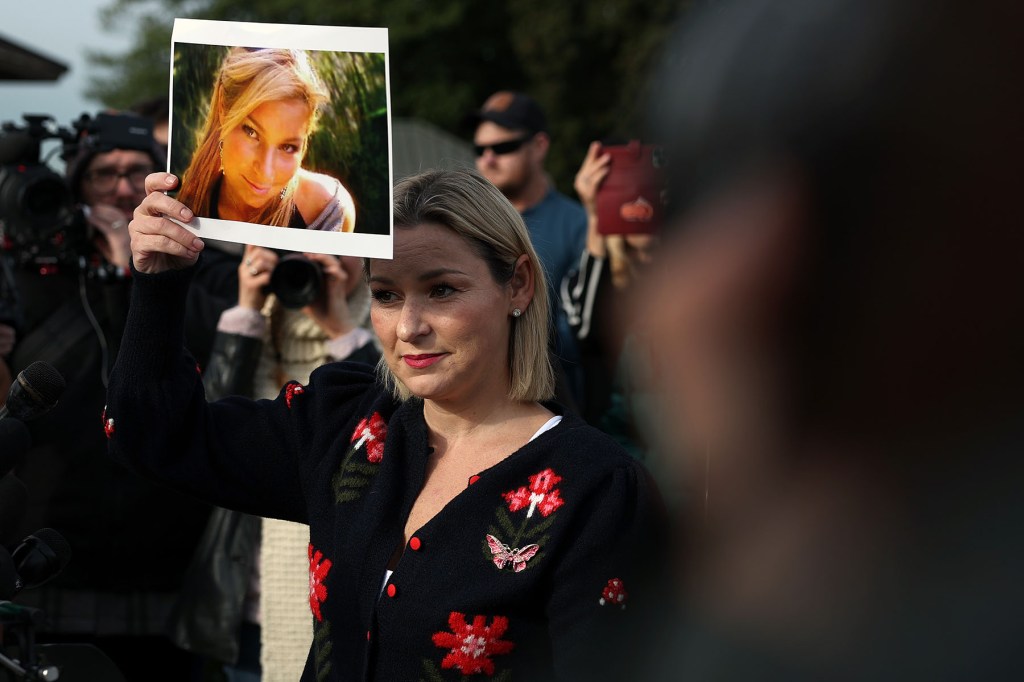 Epstein abuse survivor Danielle Bensky holds up a photo of her younger self during a news conference with lawmakers on the Epstein Files Transparency Act outside the Capitol.
