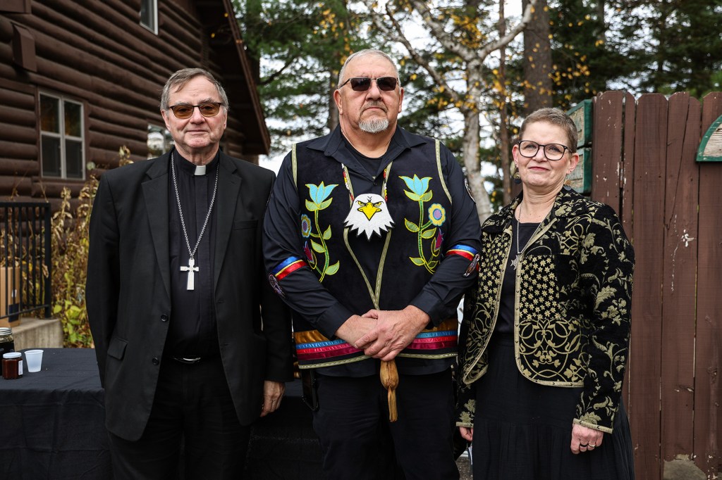 Bishop James Powers, John D. Johnson, Sr., Tribal President of the Lac du Flambeau Band of Lake Superior Chippewa Indians, and Sister Sue Ernster pose in front of the Marywood property which was returned to the Tribe.