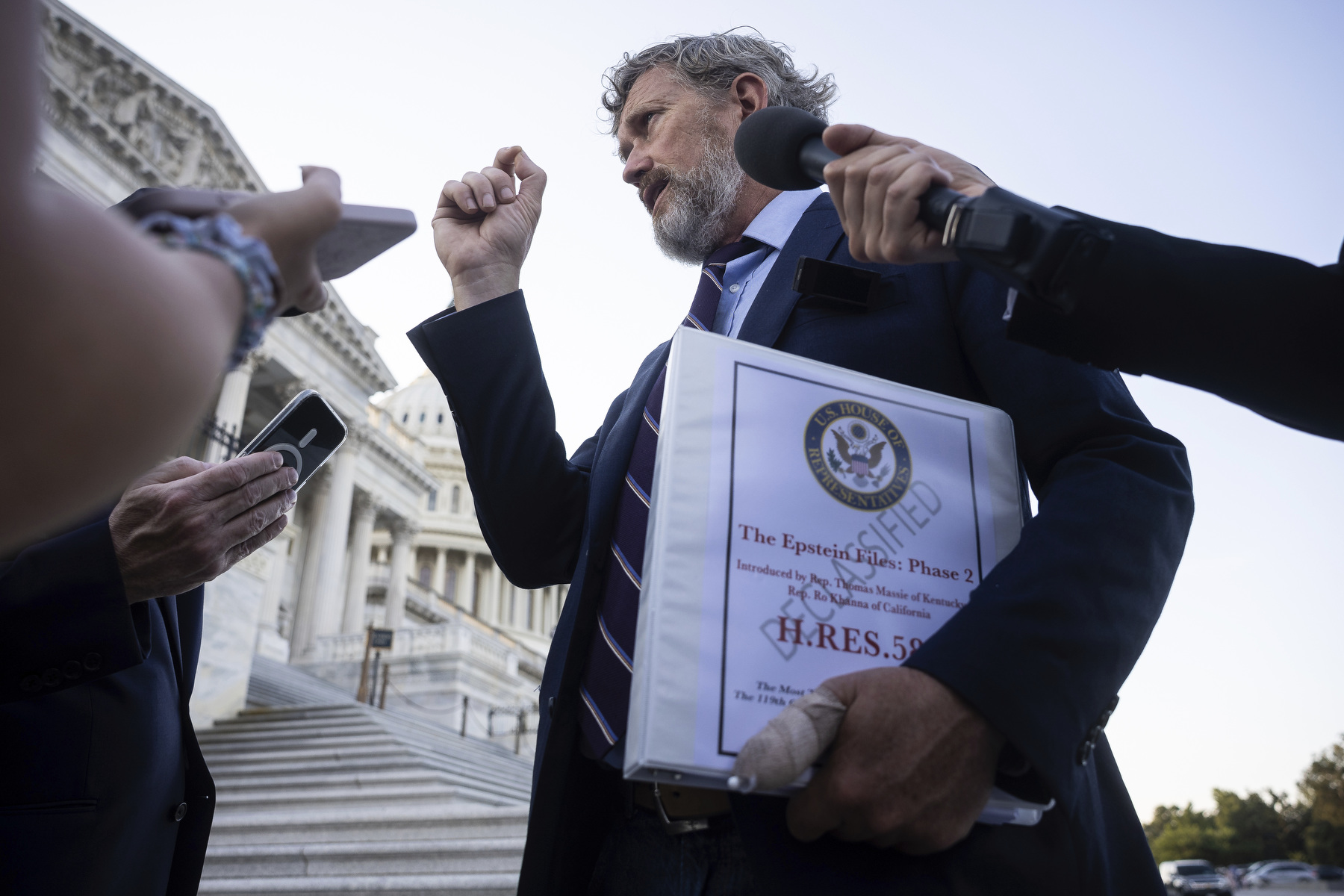 Massie is interviewed on the steps of the Capitol with a file in his hand of the proposed bill.