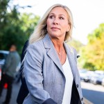Rep. Marjorie Taylor Greene, R-Ga., talks with reporters after a meeting.