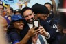 New York mayoral candidate Zohran Mamdani takes photos with supporters during a press conference.
