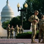 Members of the National Guard patrol Union Station. The Capitol building can be seen in the background.