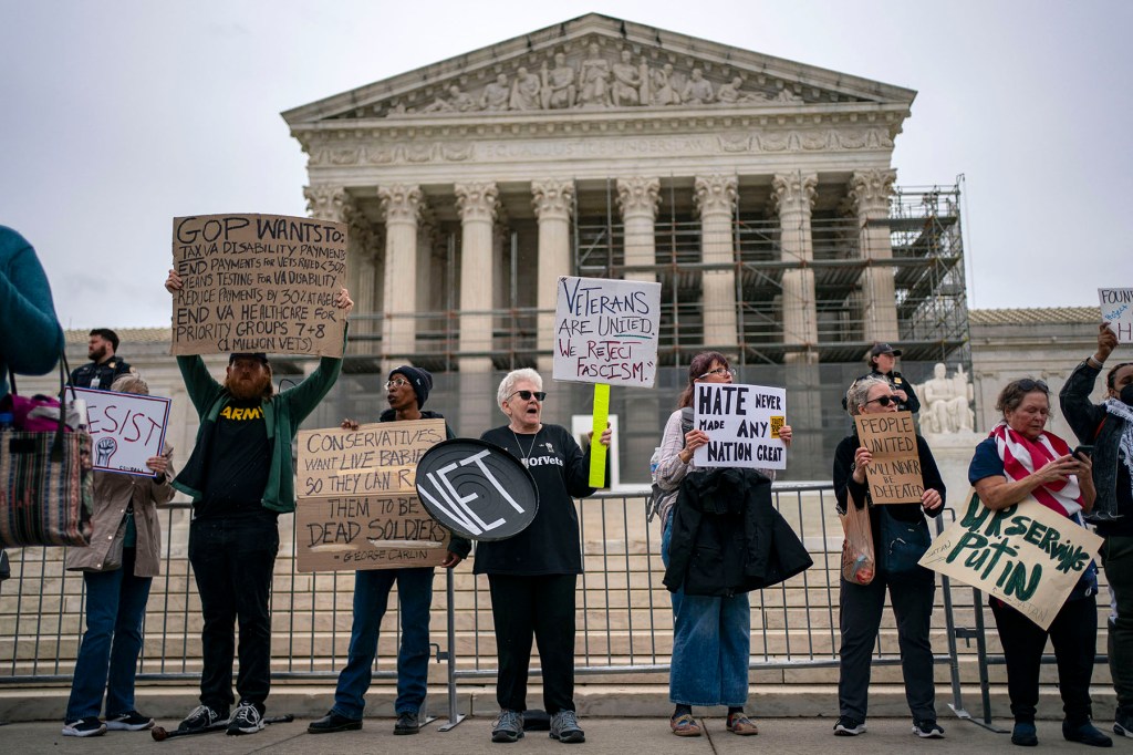 People gather to protest Project 2025 in front of the Supreme Court.