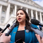 Rep. Delia Ramirez talks with reporters outside the Capitol.