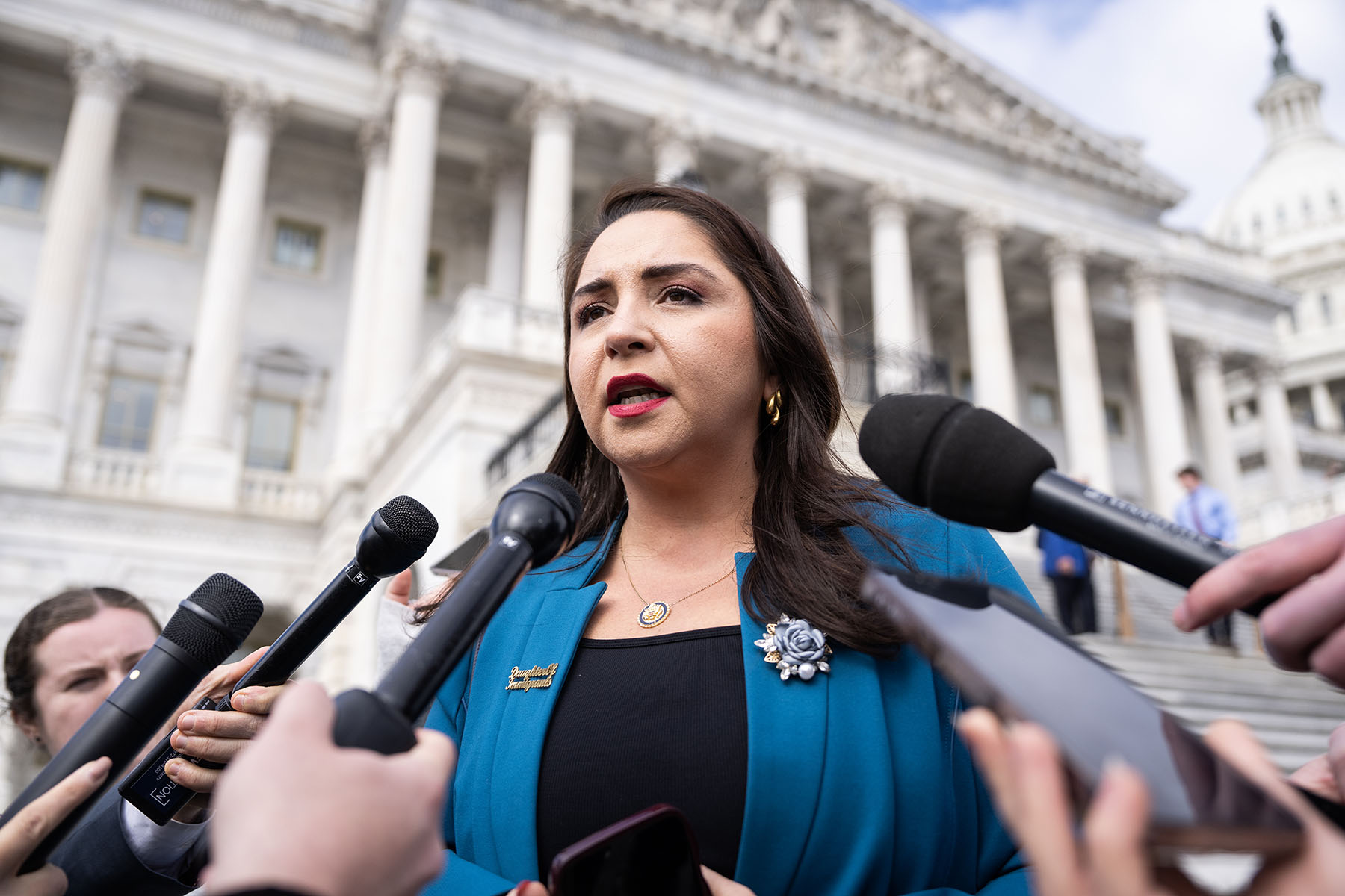 Rep. Delia Ramirez talks with reporters outside the Capitol.