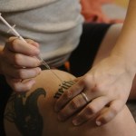 A person injects testosterone in their leg.