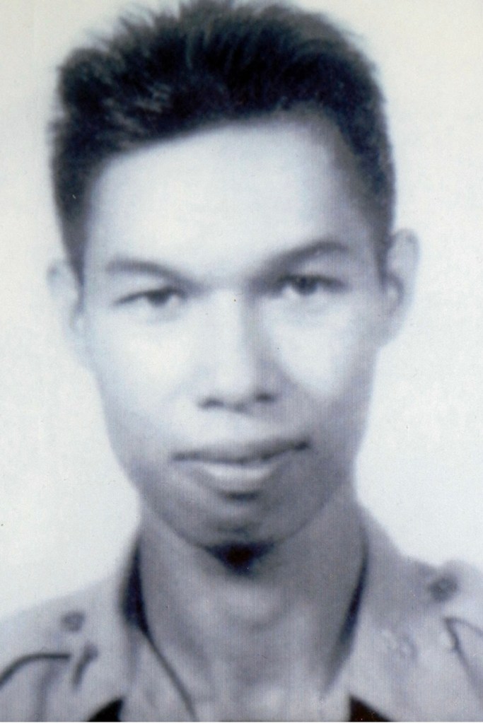 A black and white up close military portrait of a man in uniform.