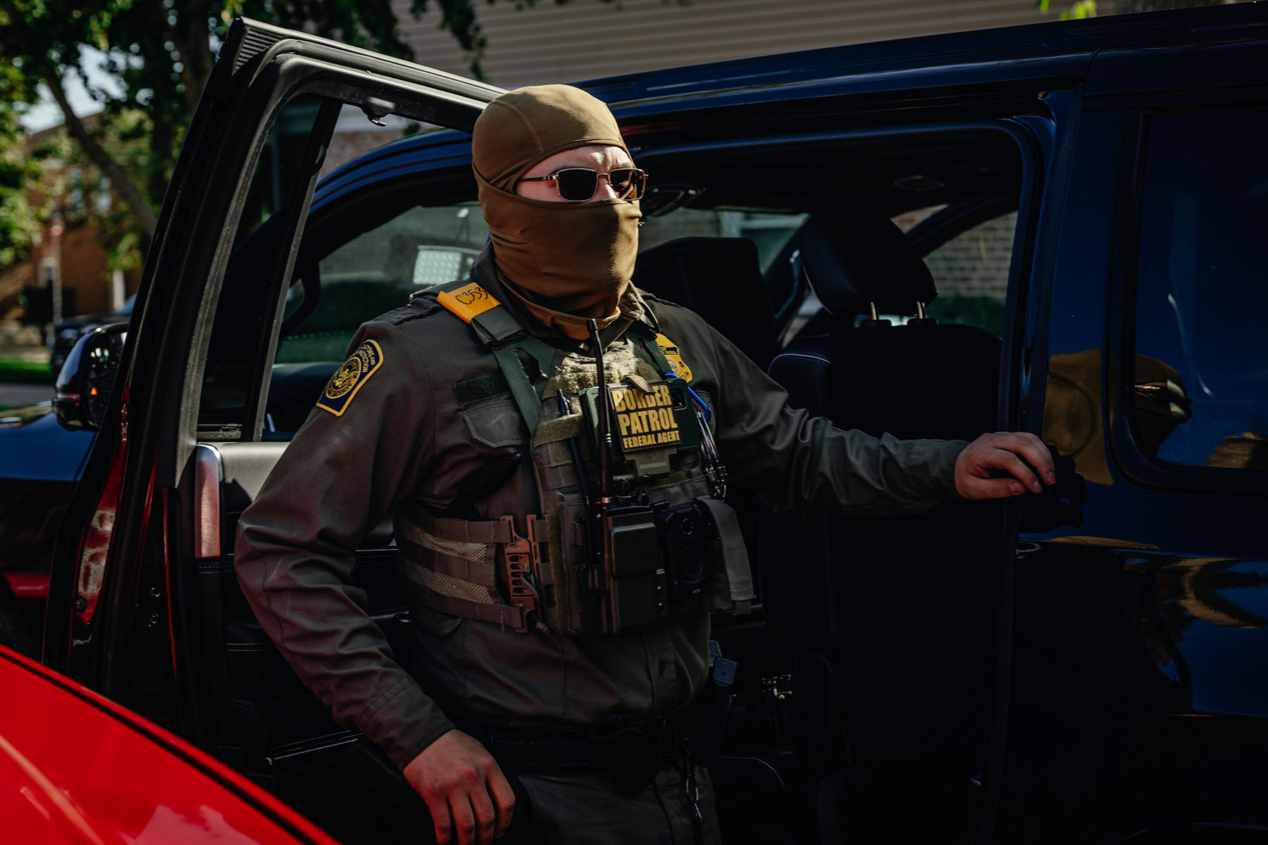 A federal agent stands near unmarked cars in Chicago, Illinois.