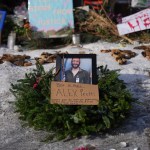 A framed photograph of Alex Petti sits at a makeshift memorial where Pretti was fatally shot by a Border Patrol officer in Minneapolis.