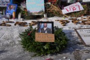 A framed photograph of Alex Petti sits at a makeshift memorial where Pretti was fatally shot by a Border Patrol officer in Minneapolis.