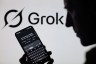 The Grok X AI app is used on a mobile phone with the Grok logo visible in the background in this photo illustration.