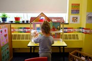 A child plays with dolls at a Head Start program at Alliance for Community Empowerment.