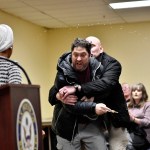 A man is tackled after spraying an unknown substance at Rep. Ilhan Omar during a town hall.