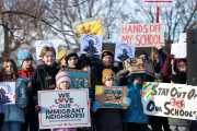 Minneapolis Public Schools families, educators and students hold signs protesting ICE and enforcement at schools