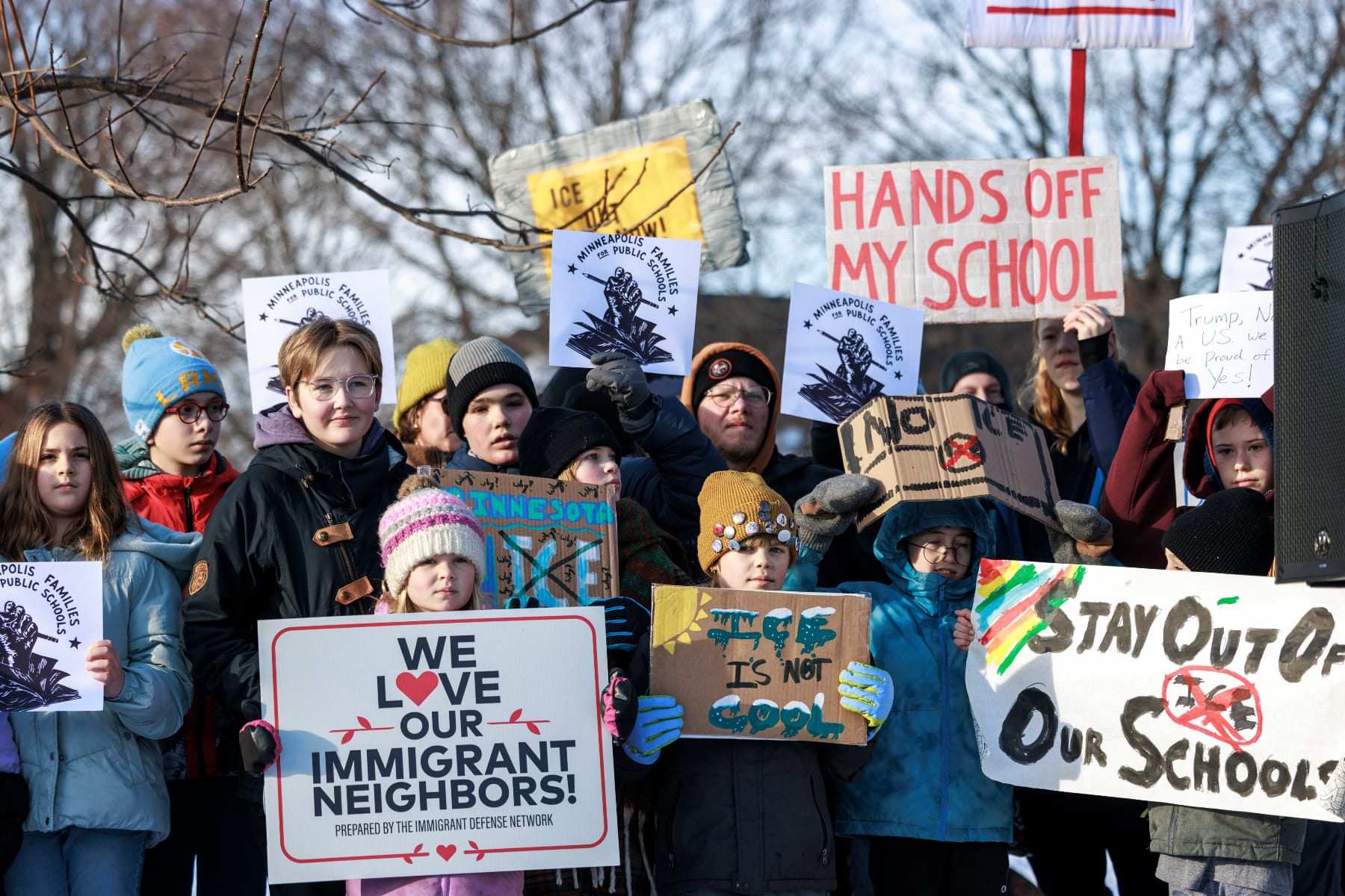 Minneapolis Public Schools families, educators and students hold signs protesting ICE and enforcement at schools