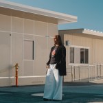 A woman stands amid temporary school trailers.