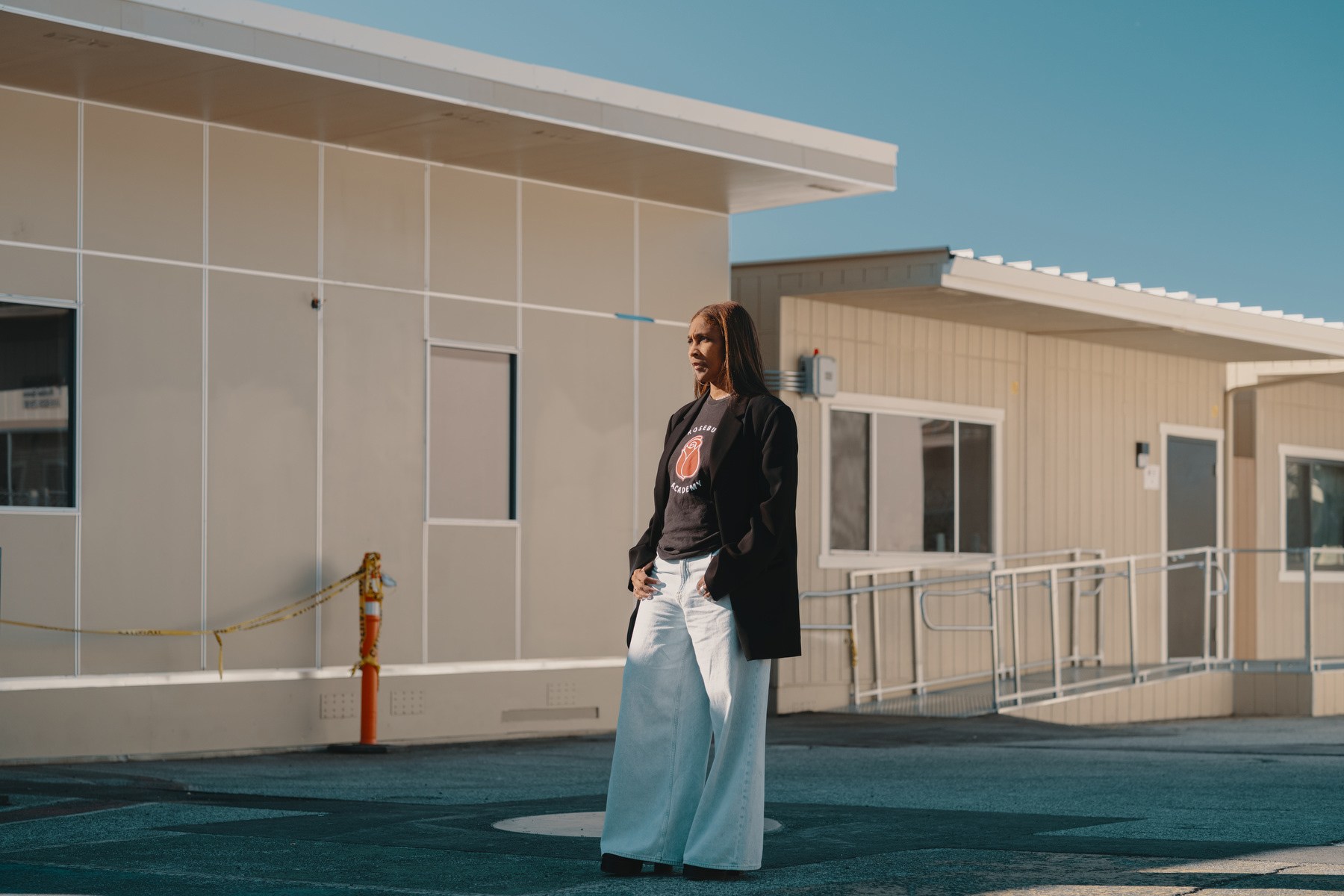 A woman stands amid temporary school trailers.