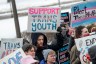Supporters bundled in winter coats hold signs reading “Support trans youth” and “Protect trans mental health” at a rally at the Minnesota State Capitol in St. Paul, Minnesota, on March 6, 2022.
