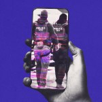 A hand holds a smartphone against a solid purple background. On the phone’s screen, a black-and-white image shows two officers walking away, wearing vests labeled “POLICE ICE,” partially obscured by pink digital glitch lines.