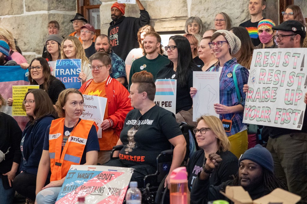 Trans people and their supporters rally at the Statehouse in opposition to Senate Bill 244.