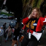 Mission High School teacher Alison White uses a bullhorn as San Francisco Unified School District teachers picket outside of Mission High School on the first day of a citywide teachers' strike.