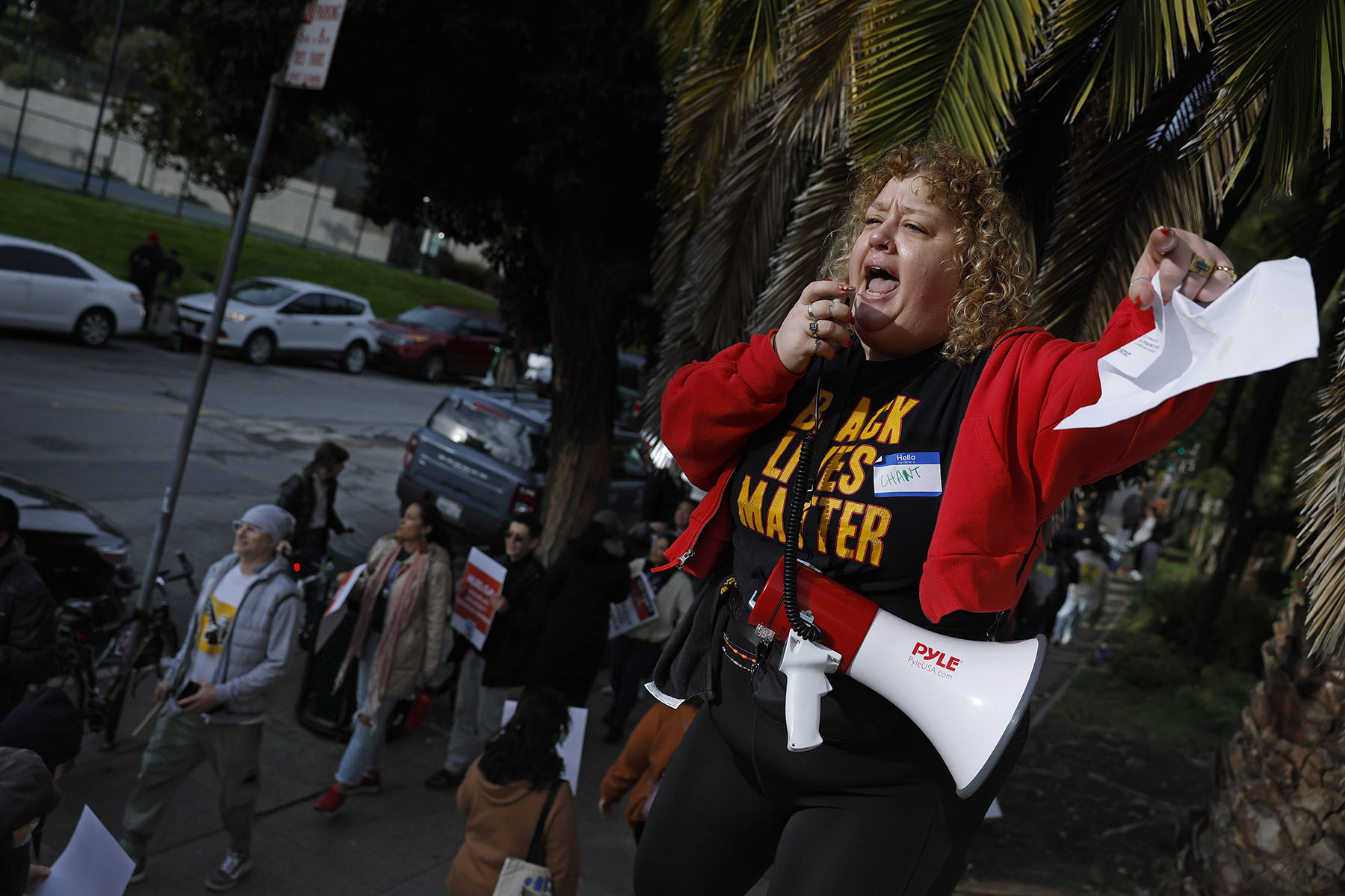 Mission High School teacher Alison White uses a bullhorn as San Francisco Unified School District teachers picket outside of Mission High School on the first day of a citywide teachers' strike.