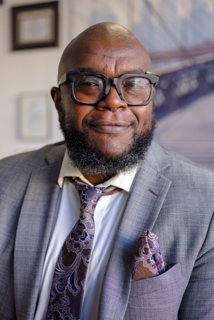 A portrait closeup of Coleman in a gray suit.